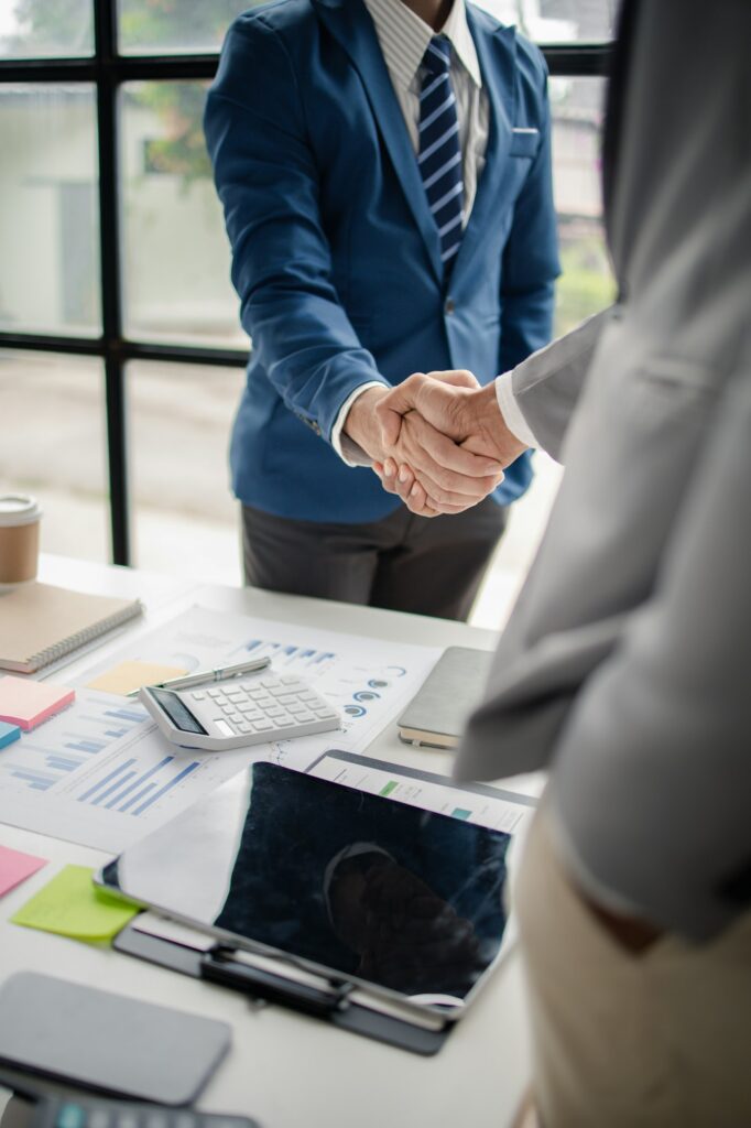 Two business men shake hands, Two businessmen are agreeing on business together and shaking hands af